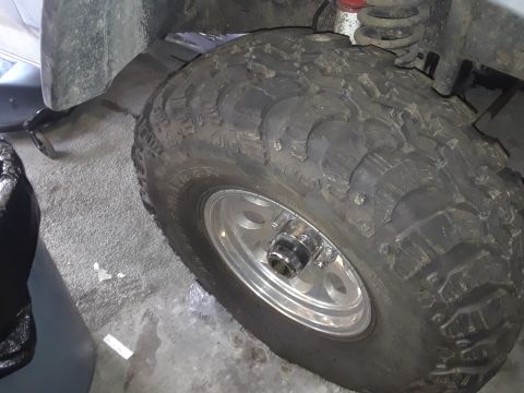 1985 Ford Bronco - Close-up view of an off-road tire and wheel assembly.