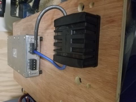 1994 Ford Bronco - Car stereo amplifier and capacitor mounted on a wooden board, with wiring connected.