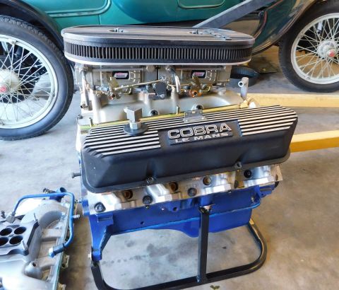 1968 Ford Mustang - A V8 engine with "COBRA LE MANS" valve covers is displayed on a stand.