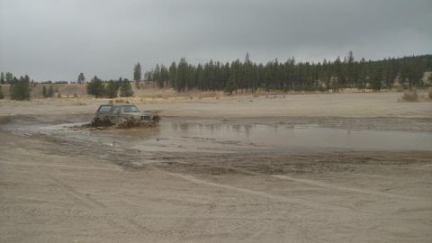 1995 Ford Bronco - Ford Bronco navigating a muddy off-road course.