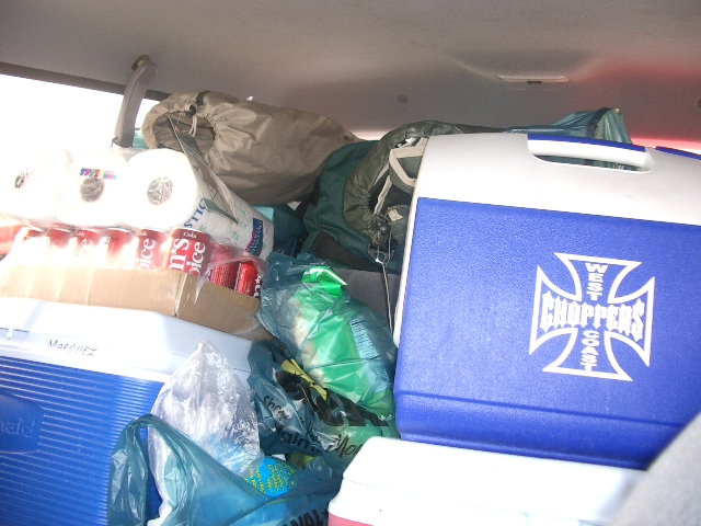 Interior view of packed vehicle with coolers and camping gear