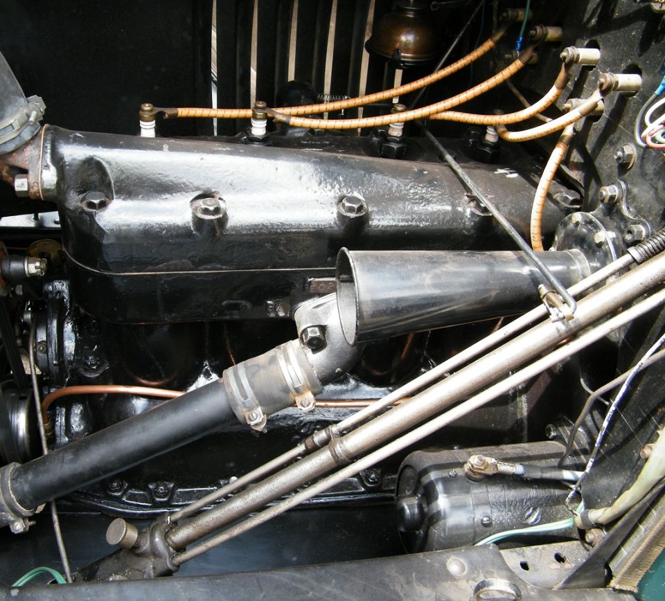 1917 Ford Model T engine block with spark plug wires and intake manifold