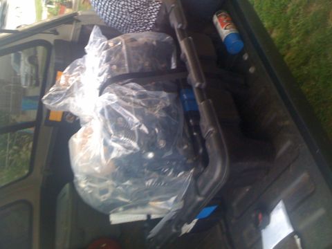 1995 Ford F-150 - An engine is being transported in the bed of a pickup truck, alongside a can of spray paint.