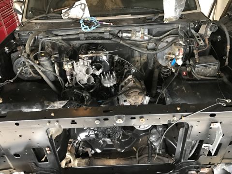 1995 Ford F-150 - The engine bay of a truck shows a disassembled engine, with various components exposed for repair or maintenance.