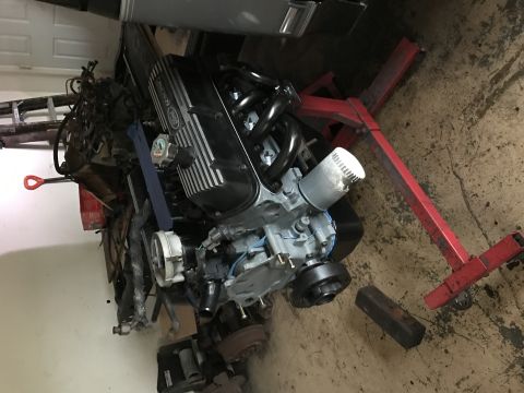 1995 Ford F-150 - Engine assembly on a stand in a garage setting, with a Supermotors.net watermark.