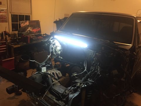 1995 Ford F-150 - Engine bay of a 1995 Ford F-150 undergoing work, with components exposed.