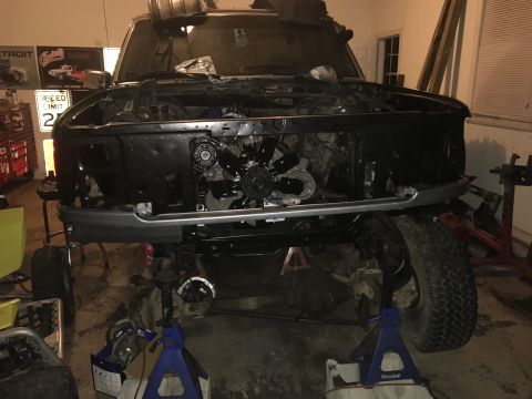 1995 Ford F-150 - This 1995 Ford F-150 is in a garage, undergoing repairs with its front end disassembled.