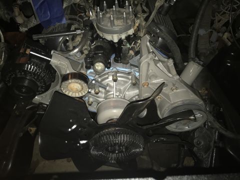 1995 Ford F-150 - Vehicle engine bay components including alternator, water pump, and fan are visible.