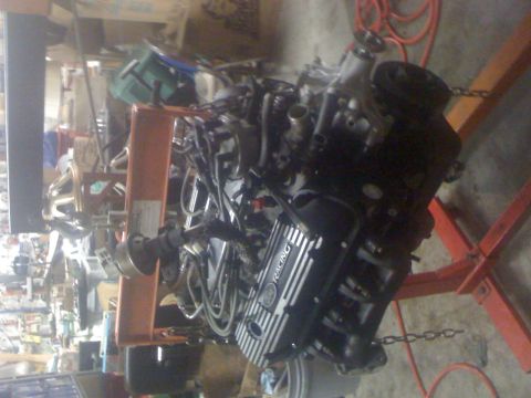 1995 Ford F-150 - This engine is mounted on an orange engine stand, "RACING" on its valve cover.