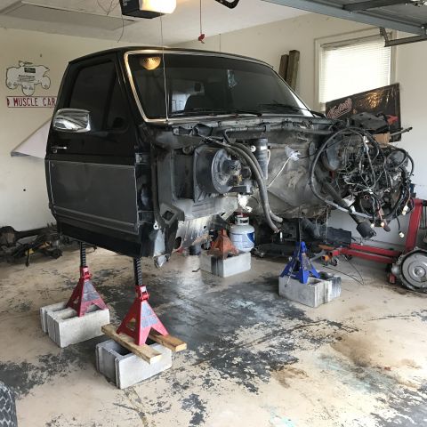 1995 Ford F-150 - A 1995 Ford F-150 is shown with its engine removed and the front end elevated on jack stands in a garage.