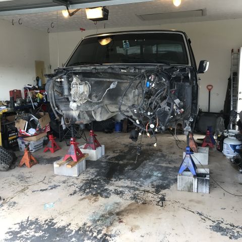1995 Ford F-150 - This truck is in a garage with its front end removed and supported by jack stands.