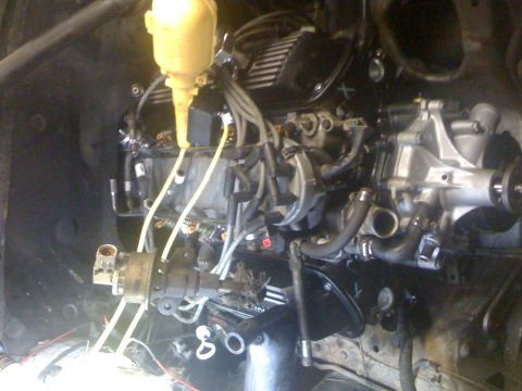 1995 Ford F-150 - Close-up view of an engine assembly, showing various mechanical parts and wiring.