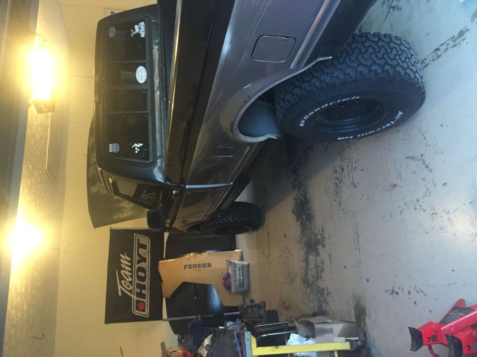Dark pickup truck rear passenger side with BFGoodrich All-Terrain T/A tire.