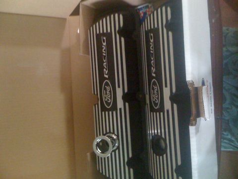 1995 Ford F-150 - Two black Ford Racing valve covers with silver pinstripes are shown inside a cardboard box. The Ford oval logo and "RACING" text are visibl…