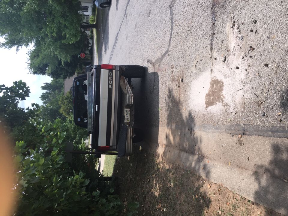 Rear driver's side of a black and silver Ford pickup truck.