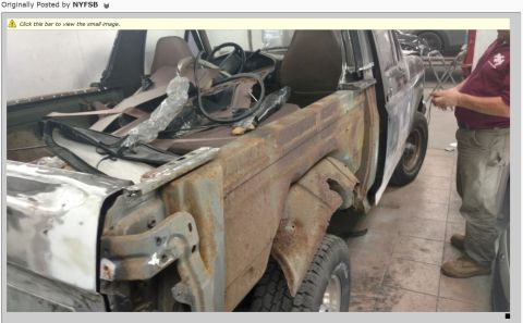 1995 Ford Bronco - Vehicle body in a repair shop, showing extensive rust and damage, with a person attending to it.