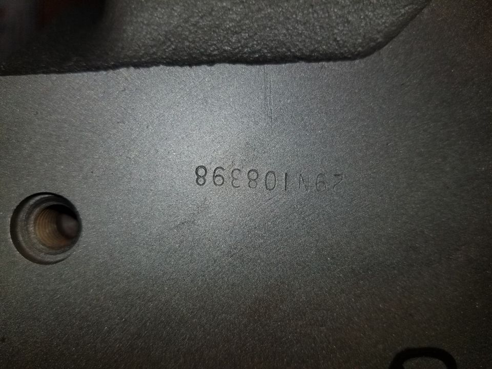 Stamped numbers 29N108398 on a dark gray metal surface with a threaded hole.