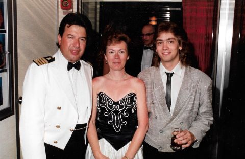 1989 Ford Bronco - Three people are posing for a photo at what appears to be a formal event. A man in a white captain's uniform stands to the left, a woman in…