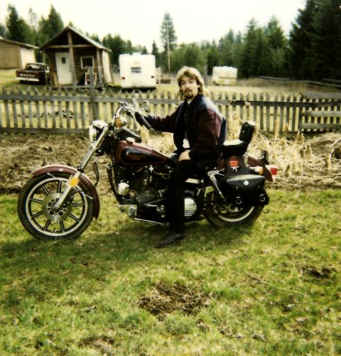 1989 Ford Bronco - A man with a mustache and mullet sits on a maroon and black motorcycle in a grassy yard. A wooden fence and some buildings are visible in t…