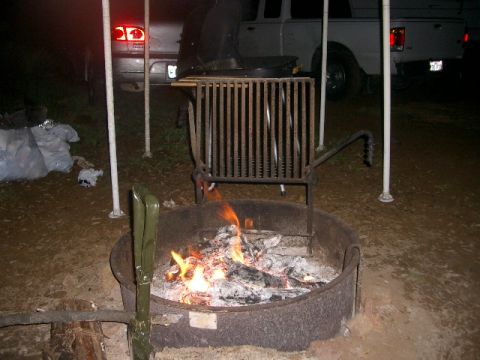1994 Ford Bronco - Two vehicles are visible at night near a campfire and grill.