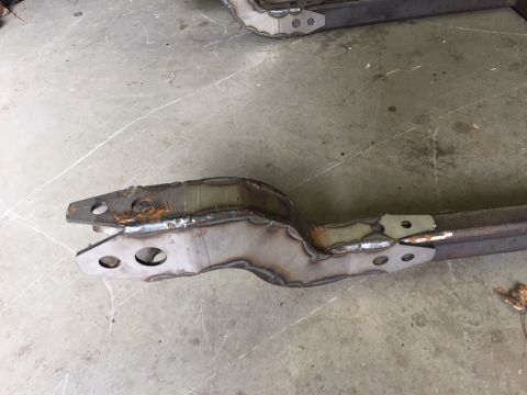 1994 Ford Bronco - A close-up view of a fabricated metal frame component, showing welds and mounting points.