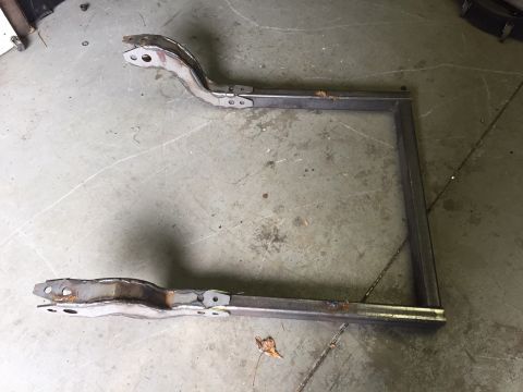1994 Ford Bronco - Custom metal frame with mounting brackets sits on a concrete floor.