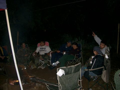 1994 Ford Bronco - People gather around a campfire at night, enjoying the outdoors and each other's company.
