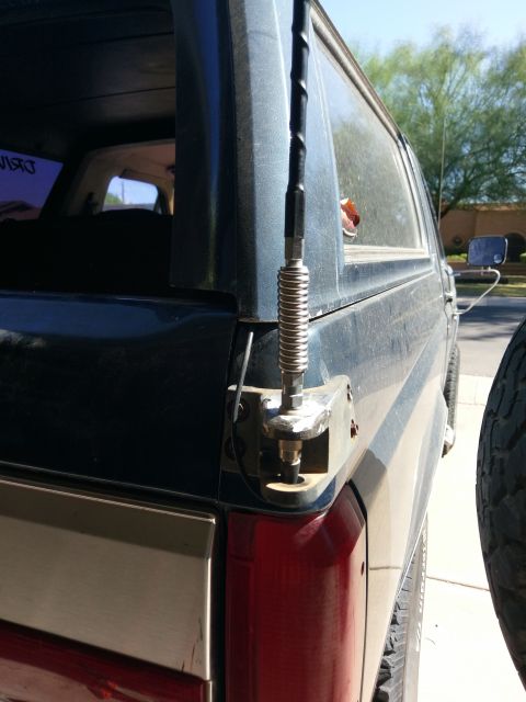 1988 Ford Bronco - Close-up of the rear corner of a vehicle, focusing on the antenna mount and taillight assembly.