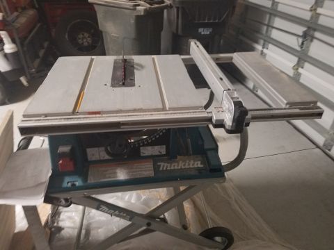 1994 Ford Bronco - A Makita table saw is shown in a garage setting, with various tools and storage bins in the background.