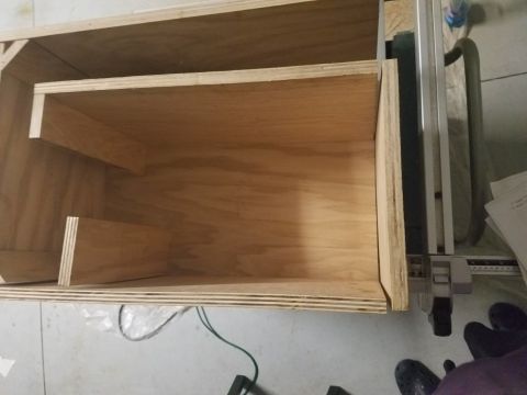 1994 Ford Bronco - A custom-built wooden enclosure, likely for speakers, is shown from the interior with visible shelving and unfinished plywood construction.