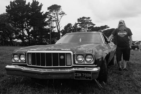 1974 Ford Ranchero - Front view of a 1974 Ford Ranchero parked outdoors with a man standing beside it.