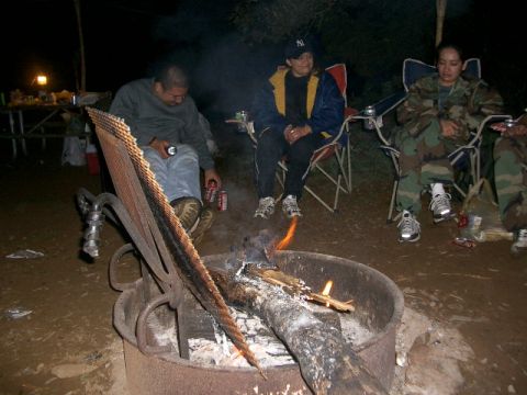1994 Ford Bronco - Campfire scene with people gathered around at night.