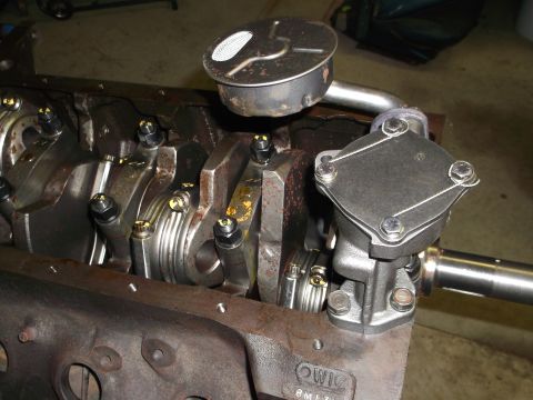 1967 Ford Mustang - Close-up view of an engine block's internal components, including the crankshaft and oil pump assembly.