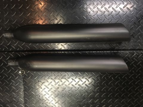 2010 Dodge Challenger - A pair of black exhaust pipes are shown against a textured metal background.