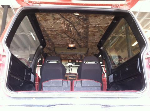 1987 Ford Bronco II - The interior of a 1987 Ford Bronco II shows a camouflage headliner and aftermarket racing seats.