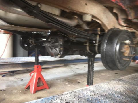 1987 Ford Bronco II - The rear axle and suspension of a 1987 Ford Bronco II are visible while supported by jack stands.