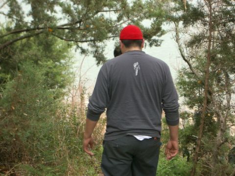 1994 Ford Bronco - Man walks through a wooded area with trees and brush.