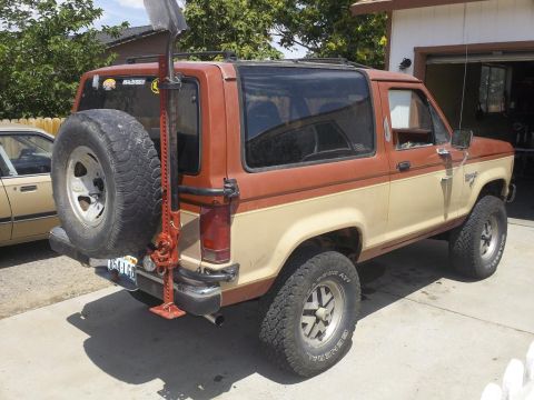 1987 Ford Bronco II - This 1987 Ford Bronco II is equipped with a rear-mounted spare tire and a Hi-Lift jack for off-road excursions.