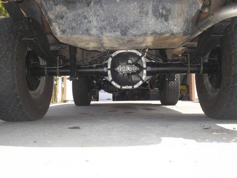 1987 Ford Bronco II - The underside of a vehicle shows its rear axle and differential, with a prominent 'SOLID' marking on the cover.