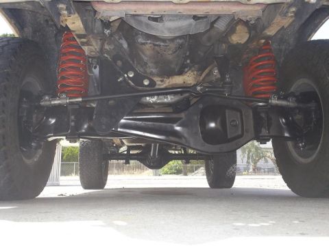 1987 Ford Bronco II - The underside of a vehicle shows its suspension components and drivetrain, with a watermark at the bottom right.