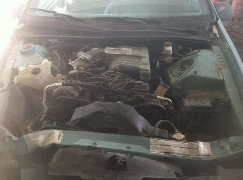 1987 Ford Bronco II - The engine bay of a vehicle, showing the V6 engine and associated components.