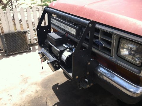 1987 Ford Bronco II - This 1987 Ford Bronco II has a custom front bumper with a winch and light bar. A radiator is visible to the side.