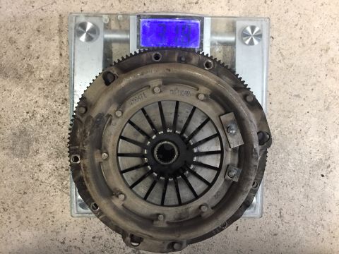 1987 Ford Bronco II - A clutch assembly is weighed on a digital scale, showing a part number for identification.