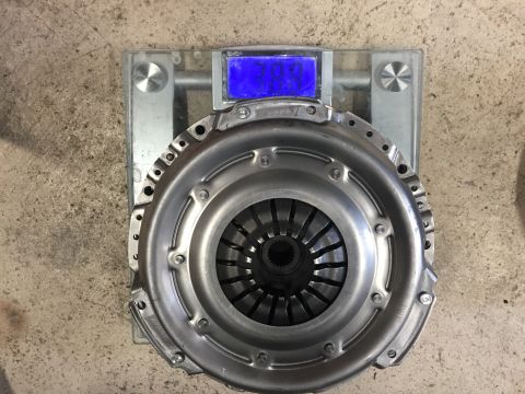1987 Ford Bronco II - A clutch assembly is weighed on a digital scale, showing a blue illuminated display.