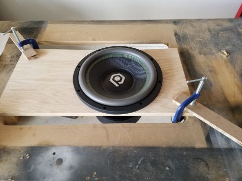 1994 Ford Bronco - Photograph of a round subwoofer driver test-fitted into a partially built plywood enclosure.
