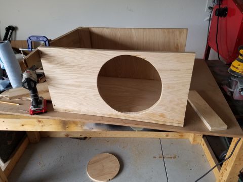 1994 Ford Bronco - Photograph of a partially assembled plywood speaker enclosure with a round speaker opening.
