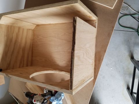 1994 Ford Bronco - Photograph of a plywood speaker enclosure being assembled on a workshop floor.