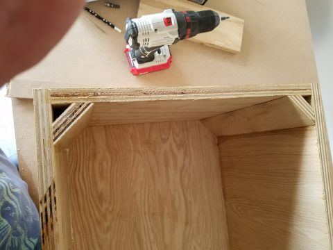 1994 Ford Bronco - Photograph of a cordless drill resting on a plywood speaker box during assembly.