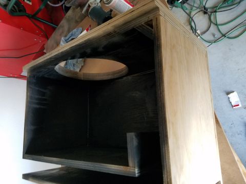 1994 Ford Bronco - Photograph of a speaker enclosure showing its dark-coated interior during construction.