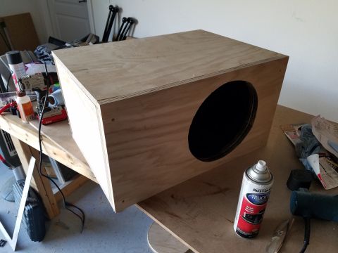 1994 Ford Bronco - Photograph of a finished plywood speaker enclosure with a black-coated circular speaker opening.